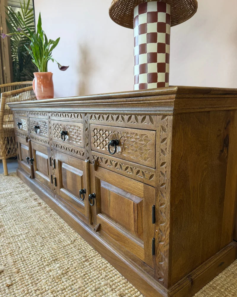Carved wood sideboard, close angled view showing carved drawer and cupboard door detail