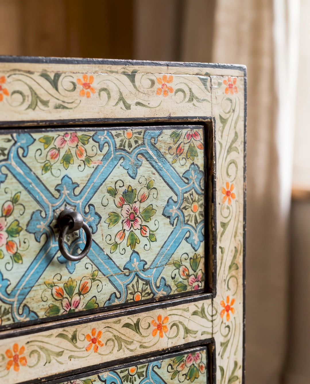 A close up of a 3 drawer hand painted mango wood chest of drawers