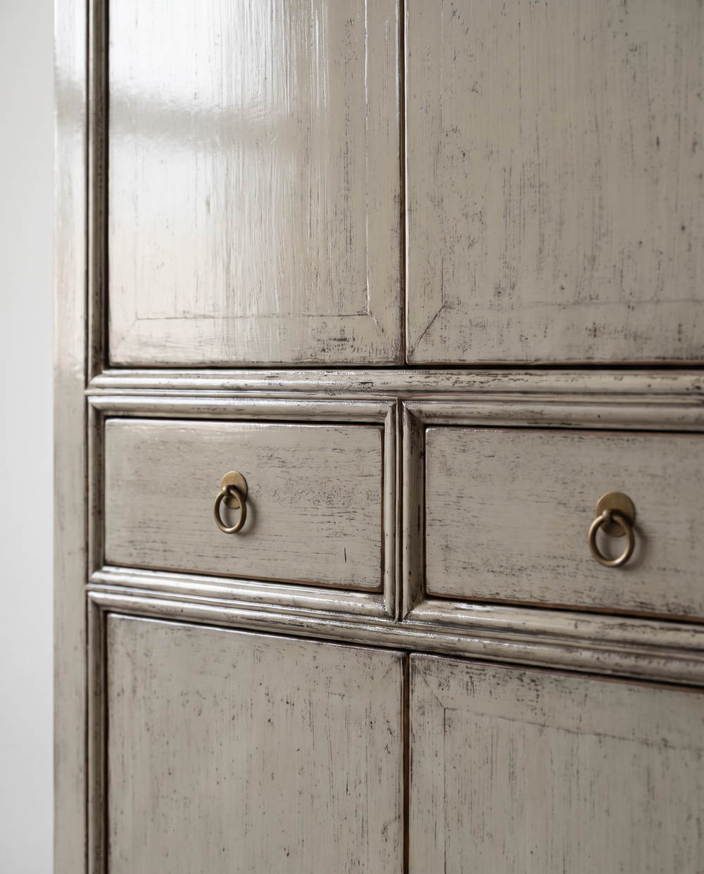 Close-up of distressed grey lacquer and metal ring drawer handles