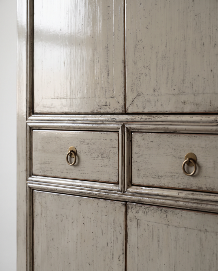 Close-up of distressed grey lacquer and metal ring drawer handles